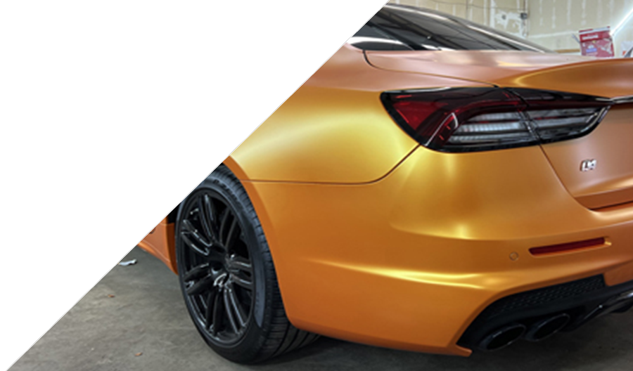 Matte orange vinyl wrap on a luxury car showcasing premium auto detailing services by Luxe Auto Salon in Colorado Springs.
